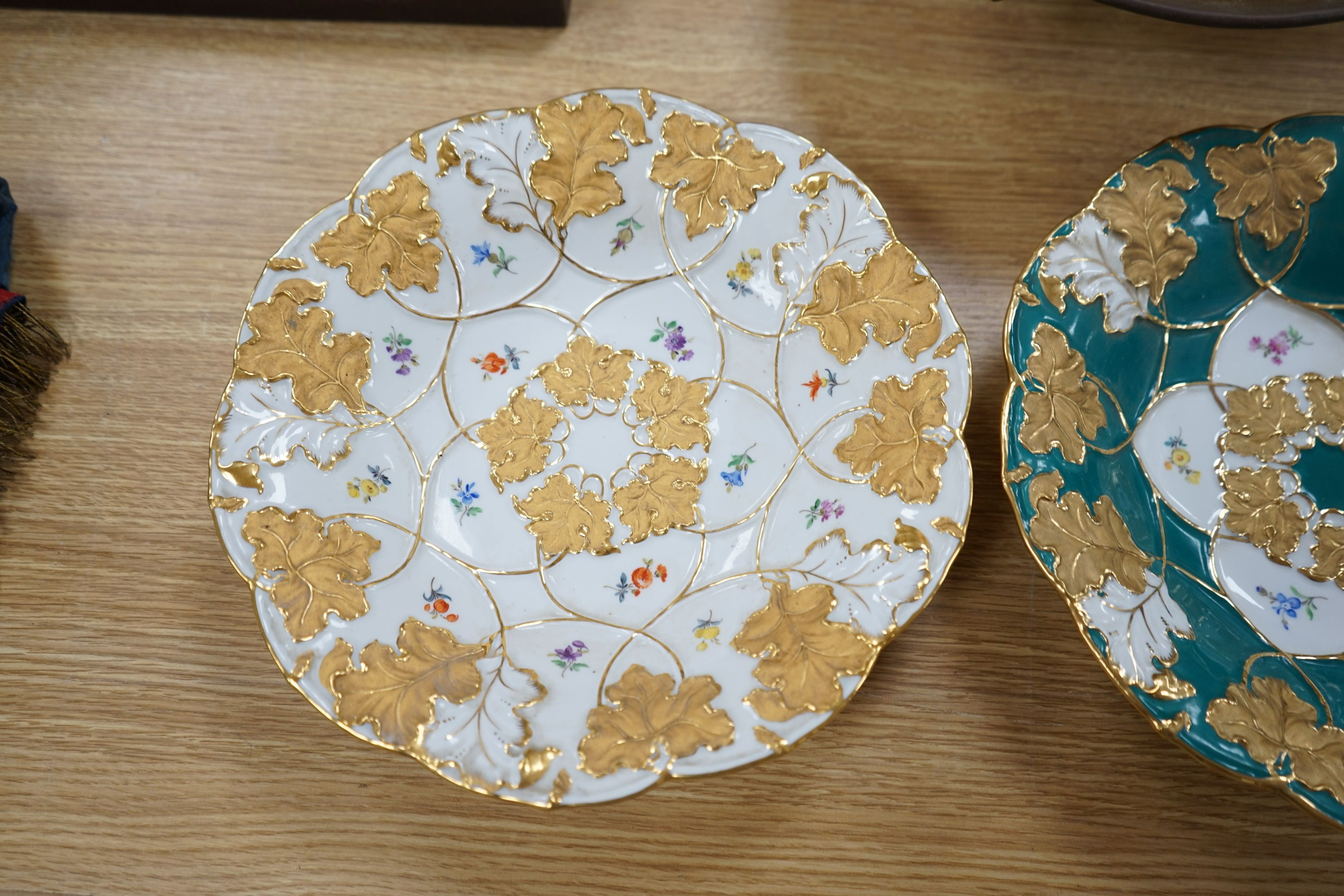 Two Meissen floral and gilt dishes and another shallower dish, 28cms diameter (3)